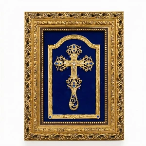Ornate gold-tone Orthodox kissing cross on royal blue velvet background in a decorative frame